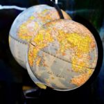 shallow focus photography of two desk globe